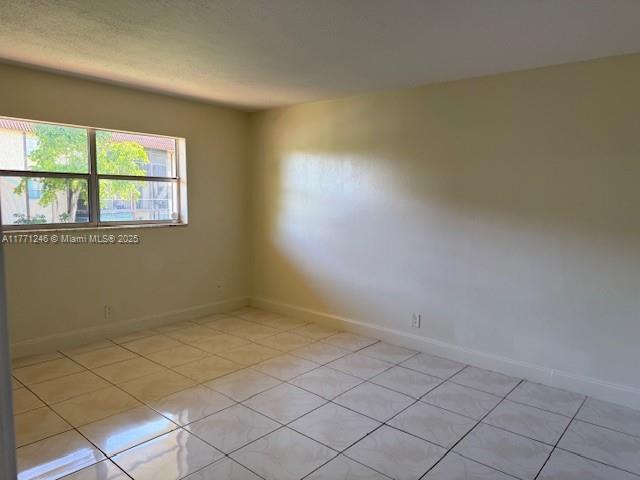 6101 N Falls Circle Dr Unit 312, Lauderhill, FL 33319 - empty room with light tile patterned floors