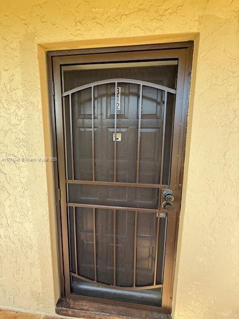 6101 N Falls Circle Dr Unit 312, Lauderhill, FL 33319 - property entrance with stucco siding