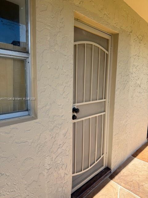 6101 N Falls Circle Dr Unit 312, Lauderhill, FL 33319 - doorway to property with stucco siding