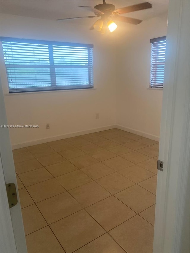 18714 SW 306th Ter, Homestead, FL 33030 - spare room featuring light tile patterned floors, a ceiling fan, and baseboards