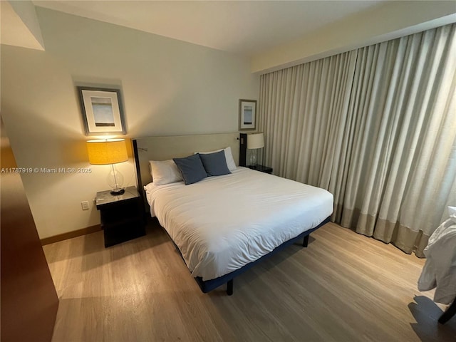 1395 Brickell Ave Unit 3211, Miami, FL 33131 - bedroom featuring baseboards and wood finished floors