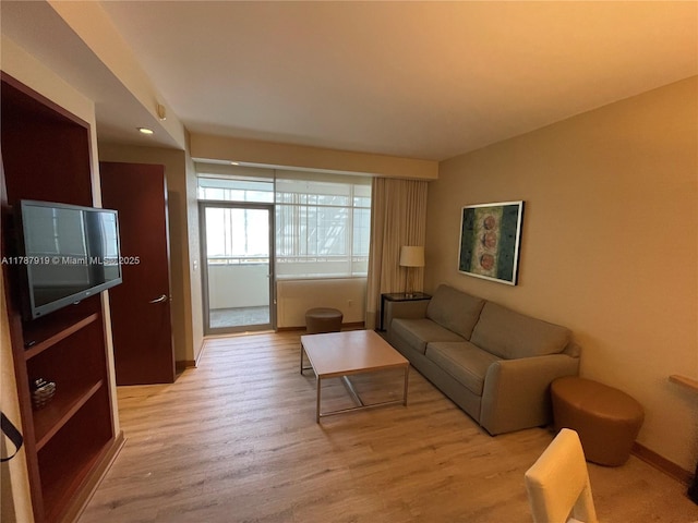 1395 Brickell Ave Unit 3211, Miami, FL 33131 - living room featuring baseboards and light wood-style flooring