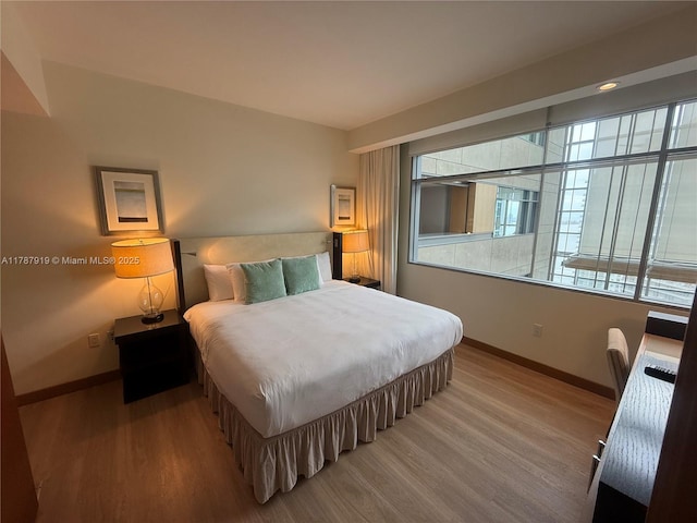 1395 Brickell Ave Unit 3211, Miami, FL 33131 - bedroom featuring baseboards and wood finished floors
