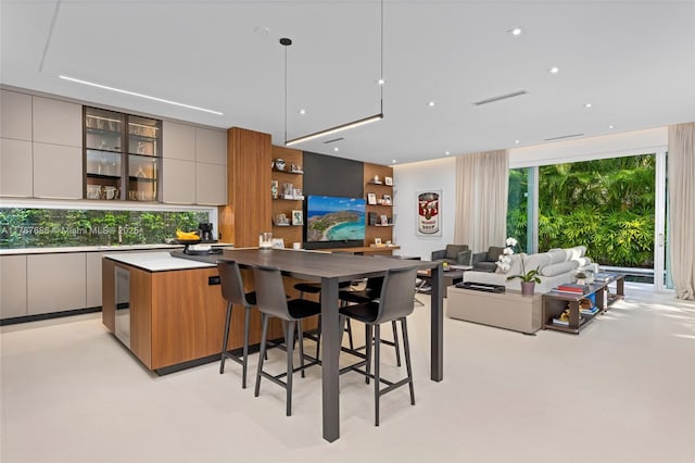4039 Ventura Ave, Miami, FL 33133 - interior space featuring a kitchen breakfast bar, open shelves, open floor plan, modern cabinets, and a kitchen island
