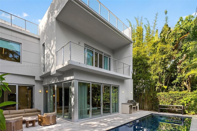 4039 Ventura Ave, Miami, FL 33133 - back of house featuring stucco siding, a balcony, an outdoor pool, and a patio