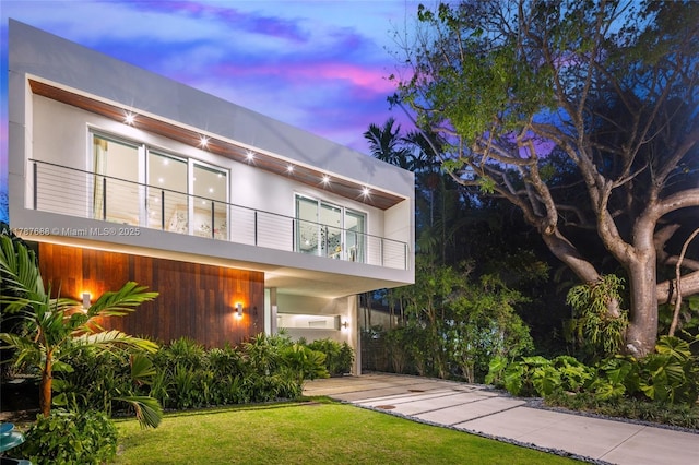 4039 Ventura Ave, Miami, FL 33133 - contemporary home with stucco siding, a balcony, and a front yard