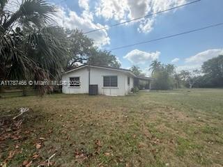 14275 SW 232nd St, Miami, FL 33170 - view of side of property featuring a lawn