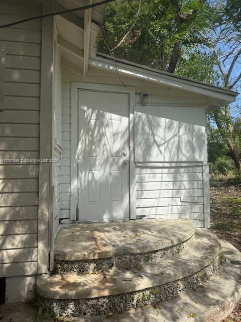 14275 SW 232nd St, Miami, FL 33170 - garage featuring a storage shed