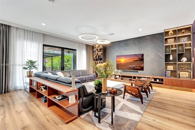 8608 Torrey Isles Ter, Boca Raton, FL 33496 - living room with an accent wall, wood finished floors, and recessed lighting