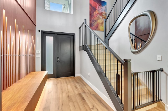 8608 Torrey Isles Ter, Boca Raton, FL 33496 - entryway featuring a towering ceiling, wood finished floors, and stairs