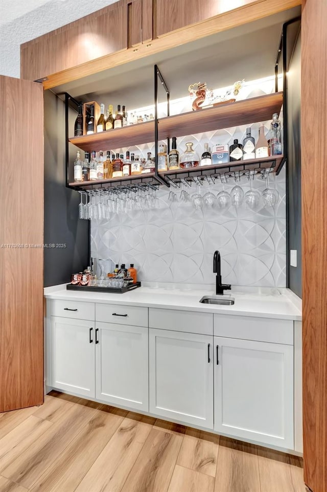 8608 Torrey Isles Ter, Boca Raton, FL 33496 - indoor bar with light wood-type flooring and decorative backsplash