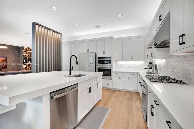 8608 Torrey Isles Ter, Boca Raton, FL 33496 - kitchen featuring appliances with stainless steel finishes, under cabinet range hood, light countertops, tasteful backsplash, and recessed lighting