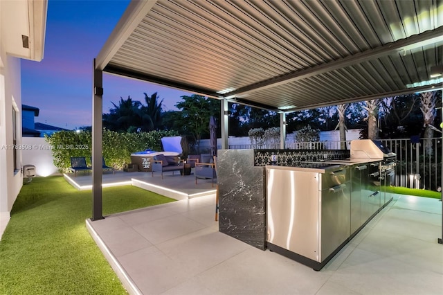 8608 Torrey Isles Ter, Boca Raton, FL 33496 - patio terrace at dusk with a patio area, an outdoor kitchen, and a fenced backyard