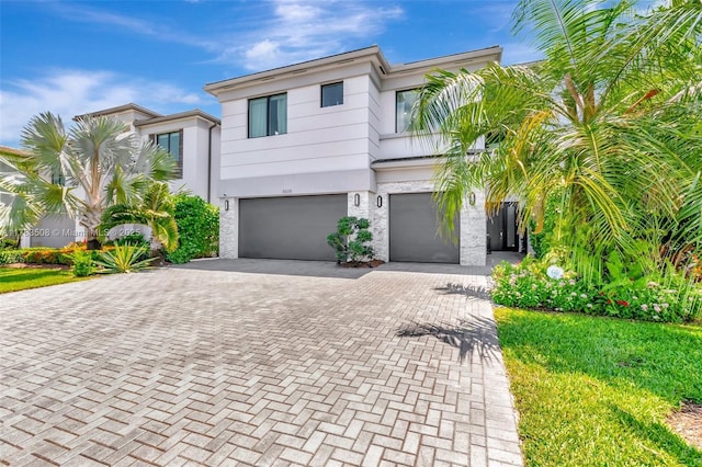 8608 Torrey Isles Ter, Boca Raton, FL 33496 - view of front facade with a garage, decorative driveway, and stucco siding