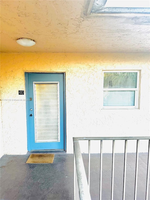 entrance to property featuring stucco siding