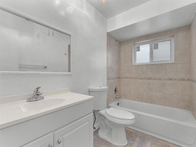 bathroom featuring bathtub / shower combination, vanity, and toilet