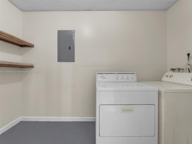 laundry room featuring separate washer and dryer, electric panel, baseboards, and laundry area