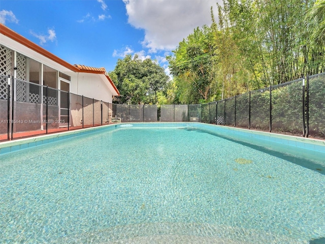 view of pool with a fenced in pool and fence