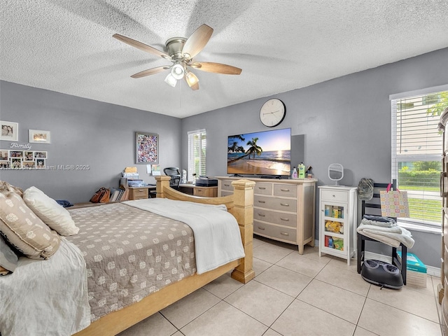 bedroom featuring a textured ceiling, a ceiling fan, and light tile patterned floors