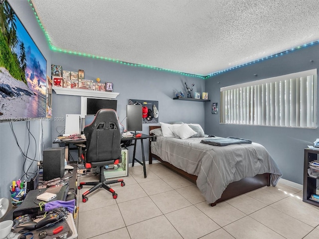bedroom featuring tile patterned flooring and a textured ceiling