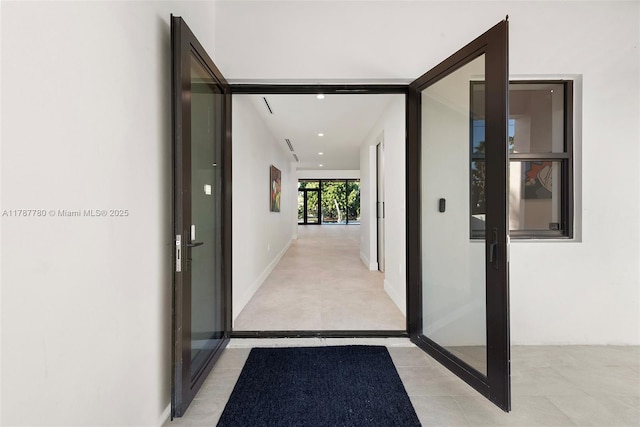 hall featuring baseboards and recessed lighting