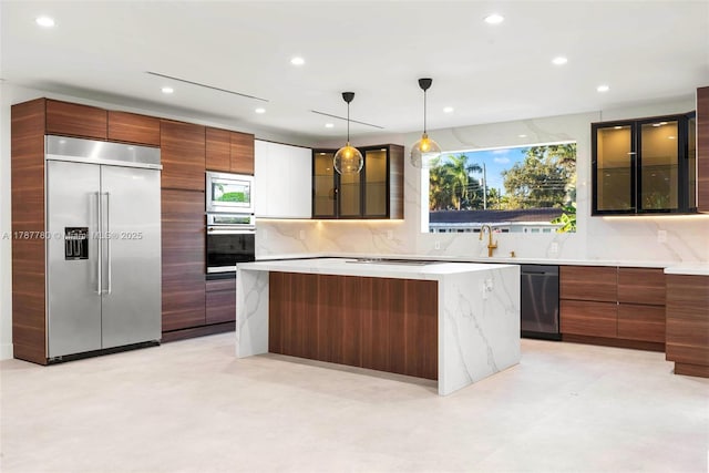 kitchen featuring modern cabinets, glass insert cabinets, a kitchen island, tasteful backsplash, and built in appliances