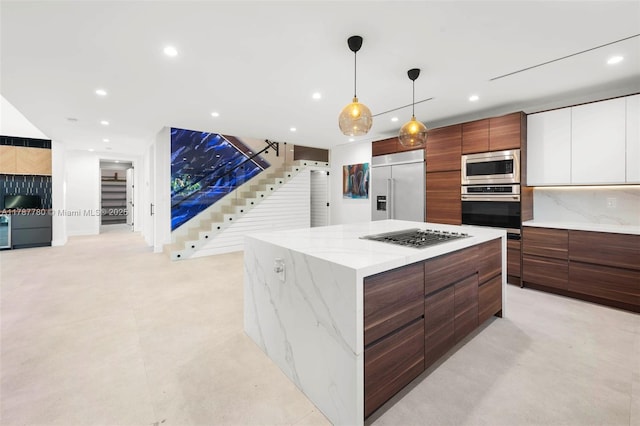 kitchen with decorative backsplash, a spacious island, built in appliances, modern cabinets, and recessed lighting