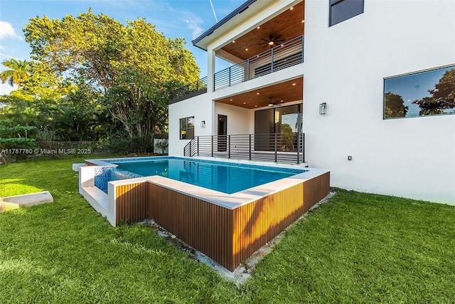 outdoor pool featuring a ceiling fan and a yard