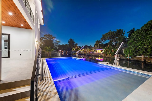 pool featuring a dock and a water view