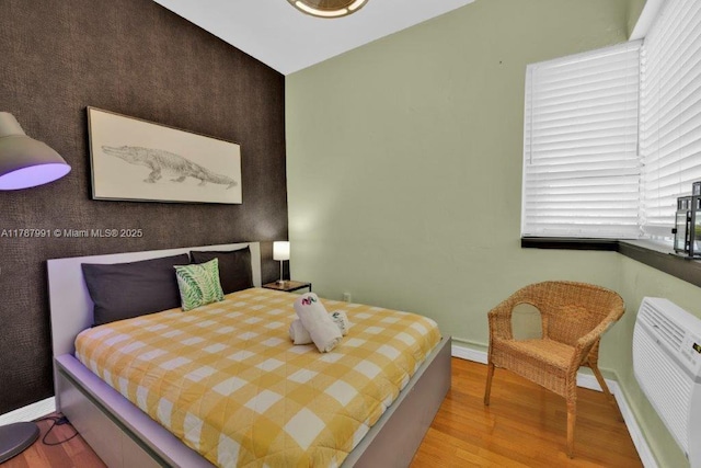 255 W 24th St Unit 136, Miami Beach, FL 33140 - bedroom with baseboards and wood finished floors