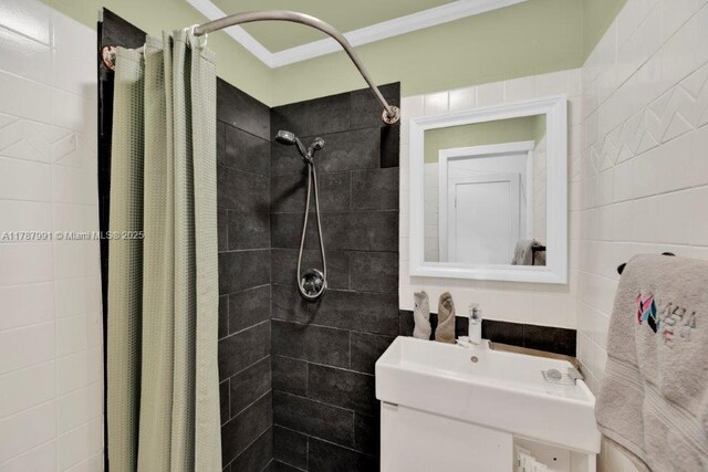 255 W 24th St Unit 136, Miami Beach, FL 33140 - full bath featuring tile walls, tiled shower, and ornamental molding