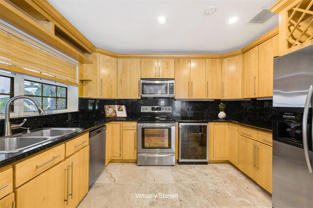 kitchen featuring wine cooler, visible vents, a sink, decorative backsplash, and appliances with stainless steel finishes