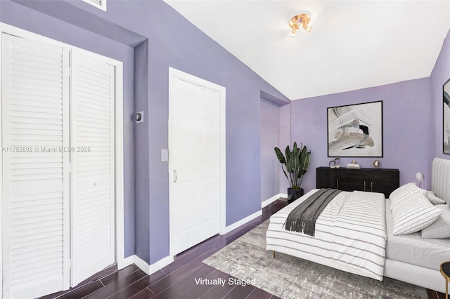 bedroom featuring vaulted ceiling, baseboards, and dark wood-style floors