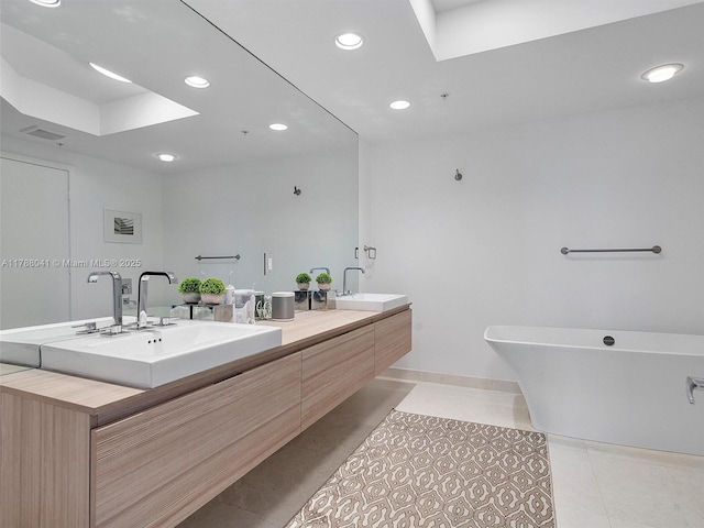 bathroom featuring tile patterned floors, a sink, double vanity, and recessed lighting