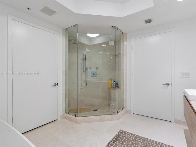 full bath featuring tile patterned floors, vanity, visible vents, and a shower stall
