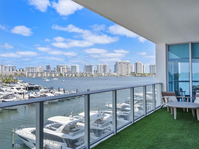 balcony featuring a water view and a view of city