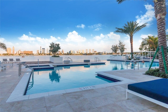community pool featuring a patio area and a view of city