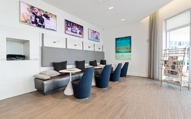 interior space featuring breakfast area, baseboards, and wood finished floors