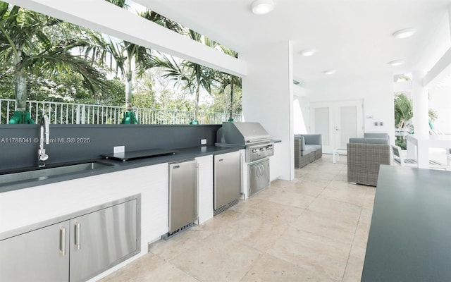 view of patio / terrace featuring french doors, a sink, a grill, fence, and area for grilling