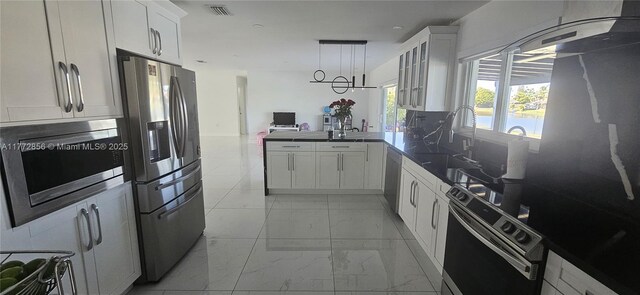 1531 SW 126th Pl, Miami, FL 33184 - kitchen featuring visible vents, appliances with stainless steel finishes, a peninsula, marble finish floor, and white cabinetry