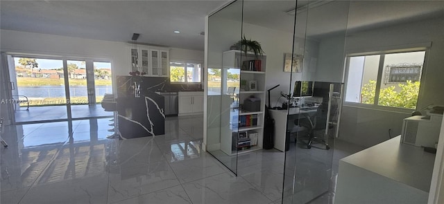 1531 SW 126th Pl, Miami, FL 33184 - kitchen with white cabinetry, glass insert cabinets, a healthy amount of sunlight, and marble finish floor
