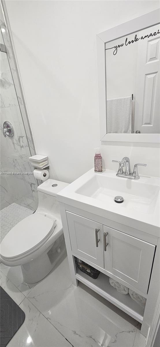 1531 SW 126th Pl, Miami, FL 33184 - full bathroom with vanity, toilet, a marble finish shower, and marble finish floor