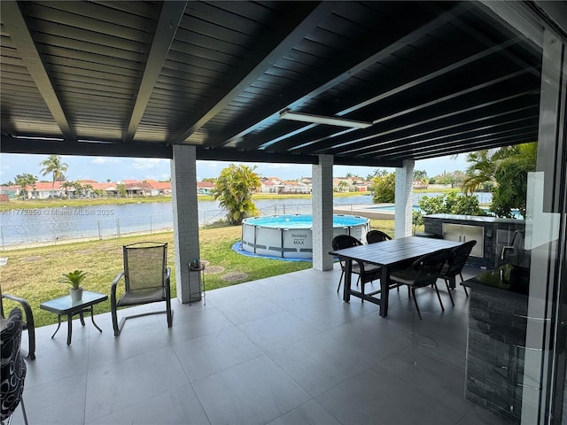 1531 SW 126th Pl, Miami, FL 33184 - view of patio with outdoor dining area, a water view, and an outdoor pool