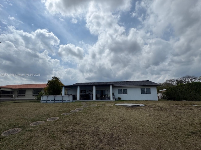 1531 SW 126th Pl, Miami, FL 33184 - rear view of property featuring stucco siding, an outdoor pool, a patio area, and a yard