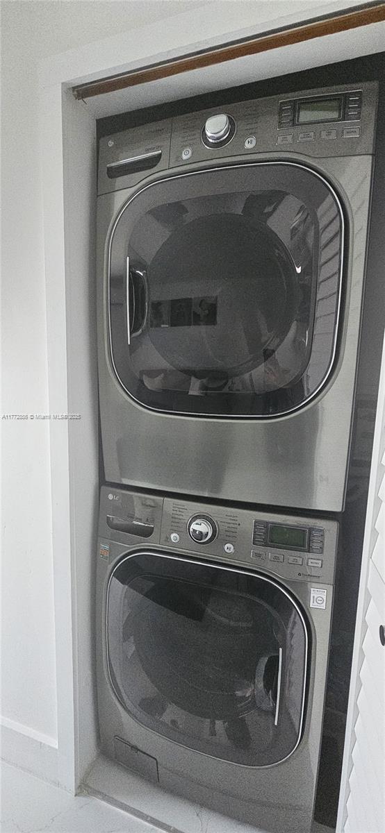 1531 SW 126th Pl, Miami, FL 33184 - clothes washing area with stacked washer and clothes dryer and laundry area