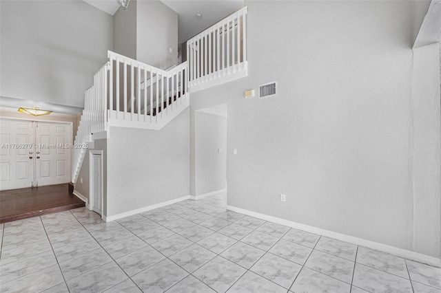 16122 SW 104th Ter, Miami, FL 33196 - stairs featuring visible vents, baseboards, a towering ceiling, and tile patterned floors