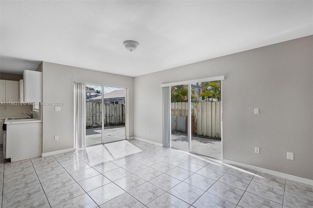 16122 SW 104th Ter, Miami, FL 33196 - unfurnished bedroom featuring baseboards, a sink, and access to outside