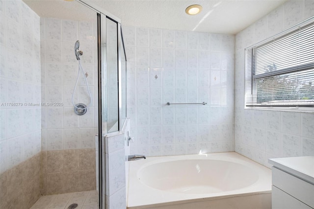 16122 SW 104th Ter, Miami, FL 33196 - bathroom with tile walls, a garden tub, vanity, and a stall shower