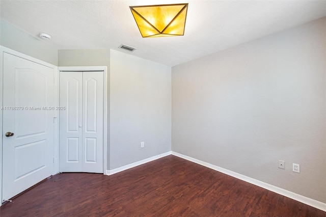16122 SW 104th Ter, Miami, FL 33196 - unfurnished bedroom featuring a closet, visible vents, baseboards, and dark wood-style floors