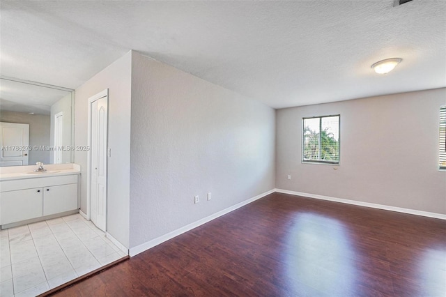 16122 SW 104th Ter, Miami, FL 33196 - empty room featuring light wood-type flooring, baseboards, and a sink